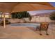 View of backyard area with a refreshing pool, covered patio, and desert landscaping at 5210 E Danbury Rd, Scottsdale, AZ 85254