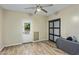 Well-lit room with wood-look flooring, features a sliding door and a separate backyard entrance at 5210 E Danbury Rd, Scottsdale, AZ 85254