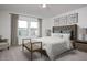 Well-lit bedroom with neutral décor, including a padded headboard and framed artwork at 5733 W Willow Ridge Dr, Laveen, AZ 85339