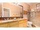 Bathroom features a double sink vanity with granite countertops and walk-in shower at 6159 W Sequoia Dr, Glendale, AZ 85308