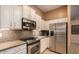 Modern kitchen boasts stainless appliances and granite counters at 6159 W Sequoia Dr, Glendale, AZ 85308