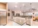 Open concept kitchen features an island, stainless appliances, and breakfast bar at 6159 W Sequoia Dr, Glendale, AZ 85308