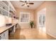 Functional office space featuring custom desk, built-in shelving, and plantation shutters at 6159 W Sequoia Dr, Glendale, AZ 85308