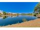 Calm community pond reflecting nearby homes and trees against a clear blue sky at 6159 W Sequoia Dr, Glendale, AZ 85308