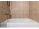 The bathroom has a clean and modern bathtub with tile surround at 6507 N 44Th Ave, Glendale, AZ 85301