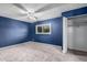 Cozy bedroom featuring neutral carpet, a closet, a ceiling fan, and ample natural light at 6507 N 44Th Ave, Glendale, AZ 85301