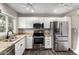 Bright kitchen featuring stainless steel appliances, granite counters, and crisp white cabinetry at 6507 N 44Th Ave, Glendale, AZ 85301