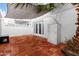 Charming patio with red brick tiles, complemented by white brick walls, perfect for outdoor relaxation and entertaining at 6507 N 44Th Ave, Glendale, AZ 85301