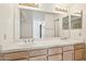 Bathroom featuring double sinks, ample counter space, and vanity lighting at 6717 E Saddleback Cir, Mesa, AZ 85215