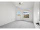 Bright bedroom featuring a ceiling fan, window with blinds, and access to the outdoors at 6717 E Saddleback Cir, Mesa, AZ 85215