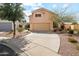 Two story home with a two car garage, a large driveway, and desert landscaping at 6717 E Saddleback Cir, Mesa, AZ 85215