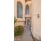 Front door with decorative cactus design, desert landscaping, and arched windows at 6717 E Saddleback Cir, Mesa, AZ 85215