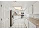 Bright kitchen with white cabinets and stainless steel appliances at 6717 E Saddleback Cir, Mesa, AZ 85215