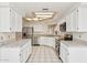 Bright kitchen featuring white cabinets, stainless steel appliances, and tile countertops at 6717 E Saddleback Cir, Mesa, AZ 85215