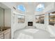 Sitting room with a fireplace, many windows, and a bar in the corner at 6717 E Saddleback Cir, Mesa, AZ 85215