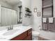 Well-lit bathroom featuring a wood vanity, modern fixtures and decorative accents at 7221 W Wood St, Phoenix, AZ 85043