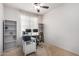 Neutral bedroom with a ceiling fan, bright natural light and shelving for storage at 7221 W Wood St, Phoenix, AZ 85043