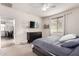 Cozy bedroom featuring carpet floors, ceiling fan, flat-screen TV, and view to the dining room at 7221 W Wood St, Phoenix, AZ 85043