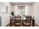 Inviting dining room with hardwood floors, dark wood table, and natural light from the large window at 7221 W Wood St, Phoenix, AZ 85043