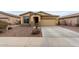 Charming single-story home featuring a two-car garage and desert landscaping at 7221 W Wood St, Phoenix, AZ 85043