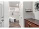 Hallway featuring modern flooring, wainscoting, and a built-in bench at 7221 W Wood St, Phoenix, AZ 85043