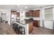 Spacious kitchen featuring dark wood cabinets, granite countertops, stainless steel appliances, and a large center island at 7221 W Wood St, Phoenix, AZ 85043