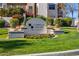 Attractive community entrance sign surrounded by manicured landscaping and vibrant flowers at 7800 E Lincoln Dr # 1007, Scottsdale, AZ 85250