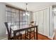 Bright dining room features a wood table, seating for two, and window views at 7800 E Lincoln Dr # 1007, Scottsdale, AZ 85250