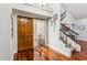 Bright entryway features wood floors, staircase, and a wooden front door with sidelight at 7800 E Lincoln Dr # 1007, Scottsdale, AZ 85250