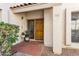 Inviting front entrance features a warm, wood door, terracotta tile, and decorative plants at 7800 E Lincoln Dr # 1007, Scottsdale, AZ 85250