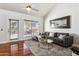 Comfortable living room features a large sectional, sleek ceiling fan, and wood floors at 7800 E Lincoln Dr # 1007, Scottsdale, AZ 85250