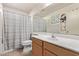 Cozy bathroom featuring a toilet, shower and sink with vanity and a large mirror at 815 E Centre Ave, Buckeye, AZ 85326