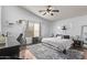 Cozy bedroom featuring wood floors, a ceiling fan, and lots of natural light, creating a warm and relaxing space at 815 E Centre Ave, Buckeye, AZ 85326