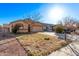 Lovely home with a two-car garage, complemented by a green lawn and mature trees creating a welcoming ambiance at 815 E Centre Ave, Buckeye, AZ 85326