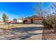 Inviting single-story home featuring a driveway, low maintenance yard, and an attached garage at 815 E Centre Ave, Buckeye, AZ 85326