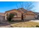 Well-maintained home with a two-car garage, a tidy front yard, and mature trees enhancing its curb appeal at 815 E Centre Ave, Buckeye, AZ 85326