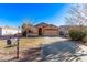 Inviting single-Gathering home showcasing a wide driveway, a two-car garage, and classic curb appeal at 815 E Centre Ave, Buckeye, AZ 85326