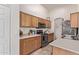 Functional kitchen with stainless steel appliances, wooden cabinets, and white countertops at 815 E Centre Ave, Buckeye, AZ 85326