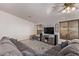 Bright living room featuring a ceiling fan, large tv, and cozy seating arrangement at 815 E Centre Ave, Buckeye, AZ 85326