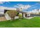 Backyard view with a patio dining set, lush lawn, and mature landscaping at 8252 E Heatherbrae Ave, Scottsdale, AZ 85251