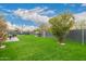 Backyard oasis with lush grass, barbecue, and patio set for al fresco dining at 8252 E Heatherbrae Ave, Scottsdale, AZ 85251