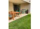 Relaxing covered back patio with modern outdoor furniture and a green artificial turf area at 8907 W Bethany Heights Dr, Glendale, AZ 85305