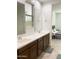 Bathroom features a double sink vanity with dark wood cabinets and a view into the bedroom at 8907 W Bethany Heights Dr, Glendale, AZ 85305