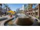 Tiered community water fountain surrounded by palm trees and retail stores at 8907 W Bethany Heights Dr, Glendale, AZ 85305