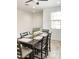 Dining room with a dark wood table and seating for six, accented by a floral centerpiece at 8907 W Bethany Heights Dr, Glendale, AZ 85305