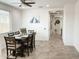 Bright dining room with a ceiling fan, tile floors, and views of the entryway and hallway at 8907 W Bethany Heights Dr, Glendale, AZ 85305