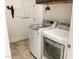 Laundry room featuring white washer and dryer units, tiled flooring, and white walls at 8907 W Bethany Heights Dr, Glendale, AZ 85305