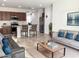 A cozy living room with a gray sofa and modern decor near an open concept kitchen at 8907 W Bethany Heights Dr, Glendale, AZ 85305