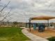 Community playground with new equipment and a shade structure on a beautiful sunny day at 8907 W Bethany Heights Dr, Glendale, AZ 85305