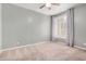 Neutral bedroom with a ceiling fan, natural light, and neutral carpet at 901 N Woodburne Dr, Chandler, AZ 85224